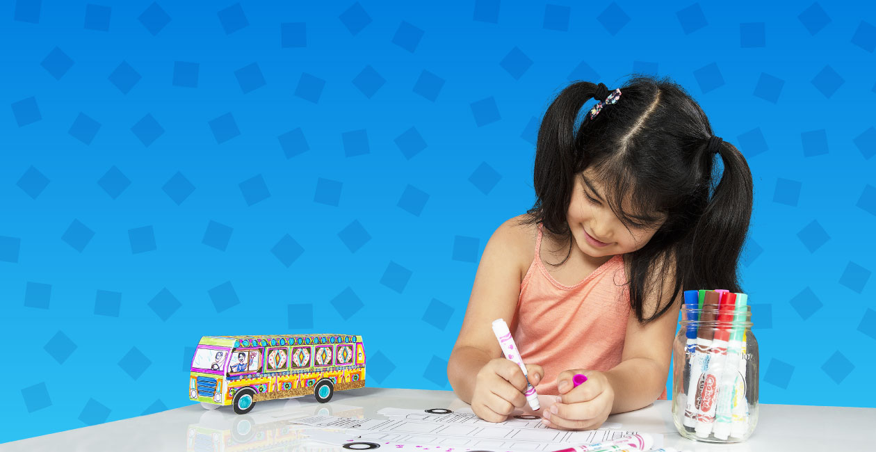 Girl decorating a Crayola bus-themed take-home project during an after-school creativity session
