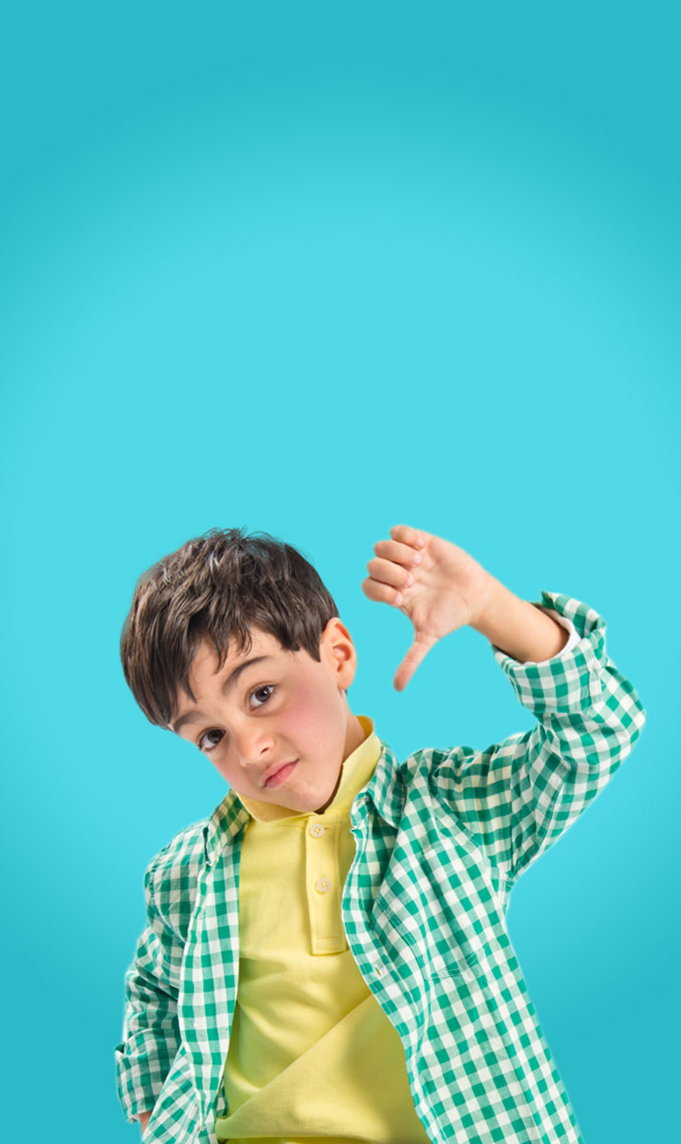 Boy standing with his thumb down.