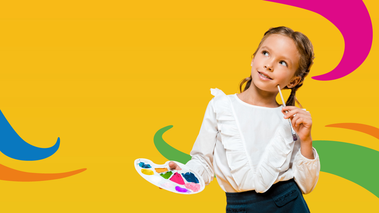 Smiling child painting during creativity session at Crayola Imagine Arts Academy SE Michigan