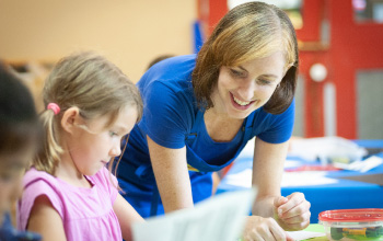 Crayola instructor guiding a child through a hands-on creative activity