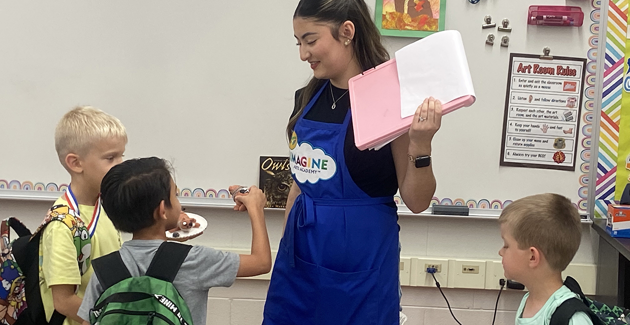 A group of children sharing their creations with the instructor